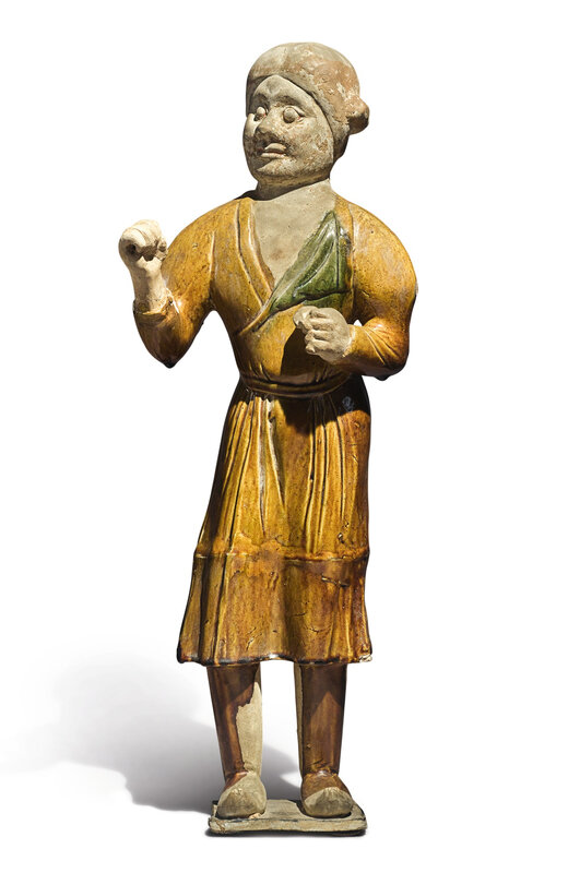 An amber and green-glazed pottery figure of a groom, Tang dynasty (618-907)
