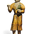 An amber and green-glazed pottery figure of a groom, Tang dynasty (618-907)