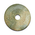 A celadon jade 'mythical bird' disc (bi), warring states period-han dynasty (475 bc-220 ad)