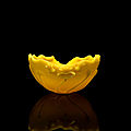 A yellow glass 'lotus leaf' water dropper