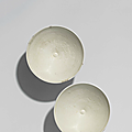 A pair of Huozhou white-glazed moulded ‘Peony scroll’ bowls, Jin-Yuan dynasty (1115-1368)