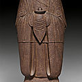 An iron figure of a standing female attendant, china, ming dynasty