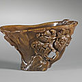 A carved rhinoceros horn 'lingzhi and peonies' libation cup, China, Qing Dynasty, 17th century
