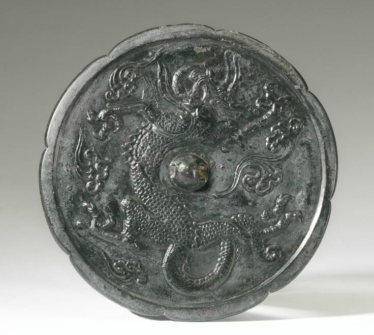 A bronze 'Dragon' octalobed mirror, Tang Dynasty