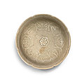 A rare lobed celadon 'auspicious objects' dish, Yuan dynasty