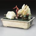 A stained ivory, jade, coral, quartz and gilt-silver 'mountain landscape' in an alabaster jardiniere, qing dynasty, 18th / 19th 