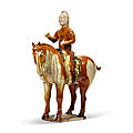 A sancai-glazed pottery figure of equestrian, Tang dynasty (AD 618-907)