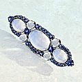Platinum, moonstone and sapphire brooch, tiffany & co., designed by louis comfort tiffany, circa 1915.