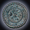 A bronze 'Lion and grapevine' mirror, Tang dynasty (618-907)