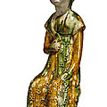 A sancai-glazed pottery figure of a seated court lady, Tang dynasty (618-907)