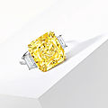 A fancy vivid yellow diamond and diamond ring