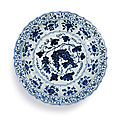 An exceptional and rare blue and white barbed 'grape' charger, ming dynasty, yongle period (1402-1424)
