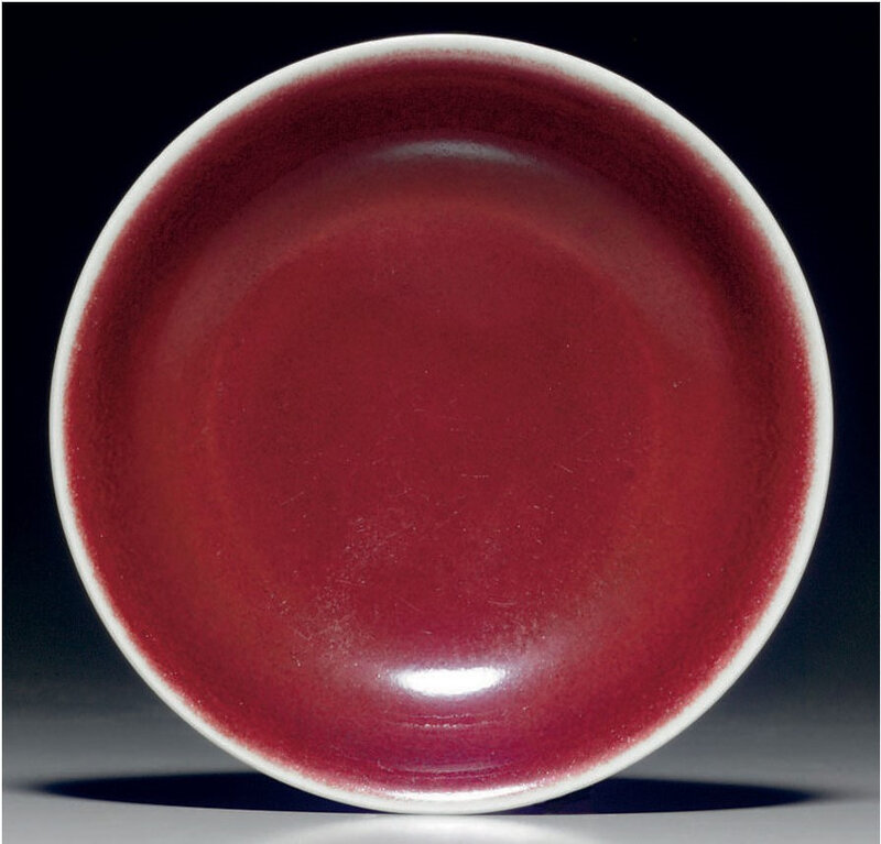 A rare imperial copper-red-glazed shallow dish, Xuande six-character incised mark within a double circle and of the period (1426-1435) (2)