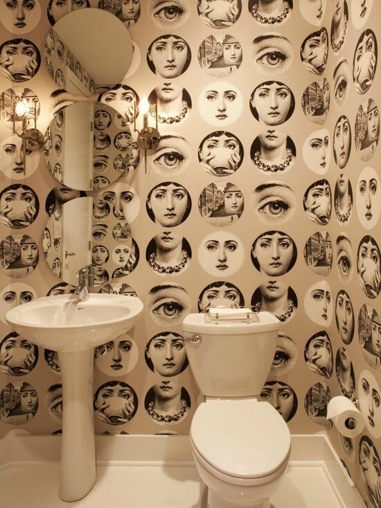 fornasetti plates gray wallpaper in powderroom bathroom